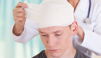 A man with a bandage wrapped around his head